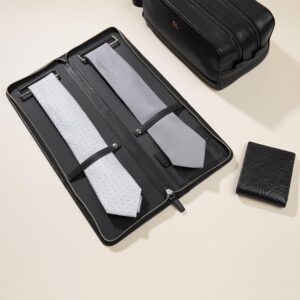 A black leather travel case with a tie and a briefcase.