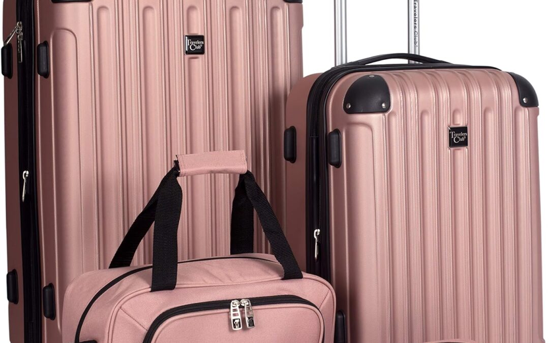 Four pieces of pink luggage with handles and wheels.